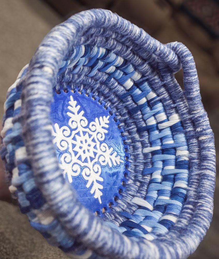 Woven blue yarn basket with a snowflake bottom