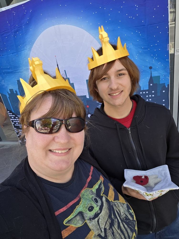 Logston and Ayden wearing yellow paper crowns