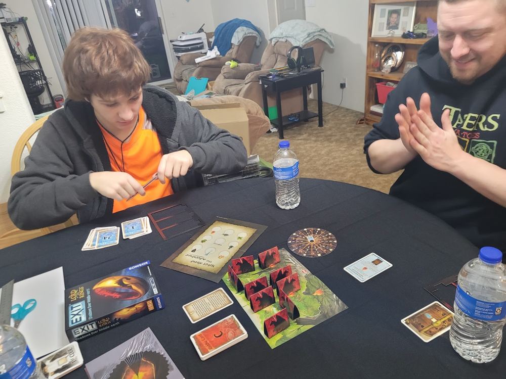 Family playing an escape-room board game at the kitchen table
