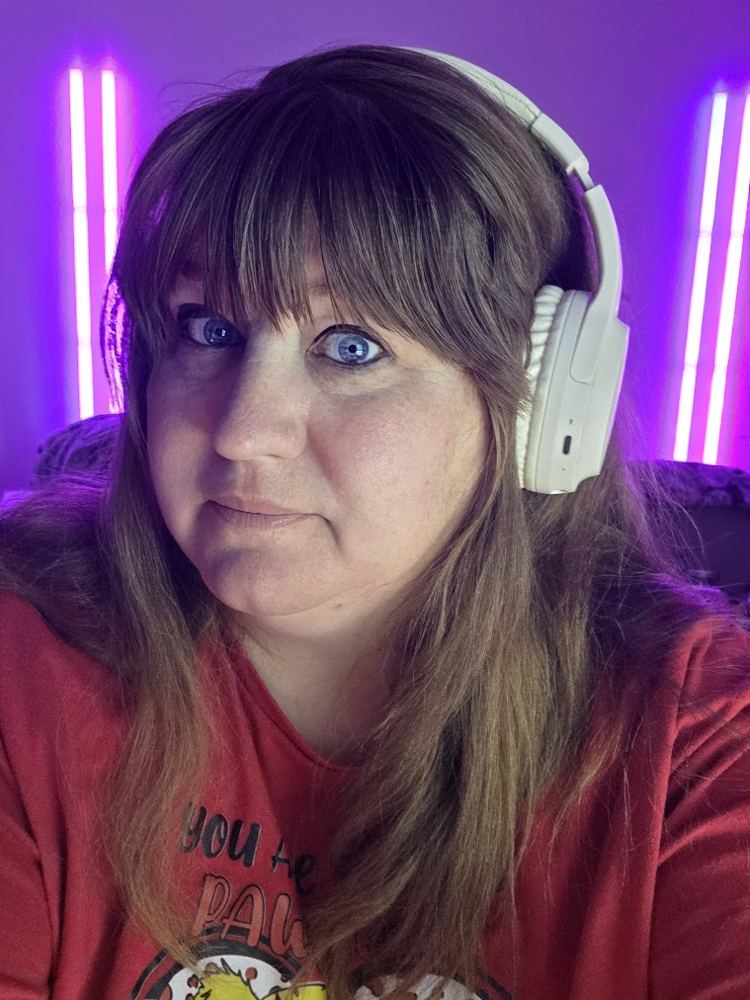 Logston wearing white headphones in a room with purple lights